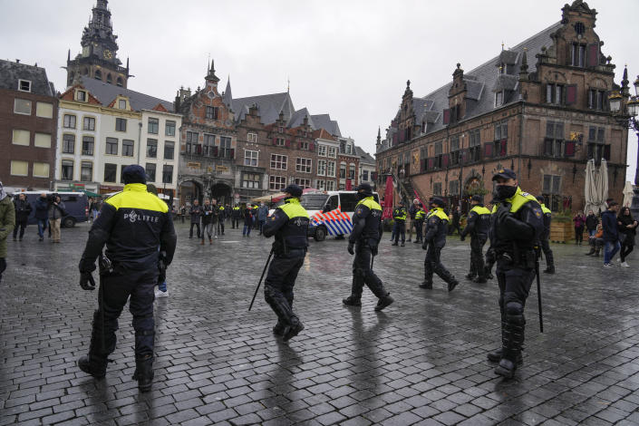 Police patrol the city center after a demonstration against COVID-19 restrictions and lockdown was banned in Nijmegen, eastern Netherlands, Sunday, Nov. 28, 2021. (AP Photo/Peter Dejong)