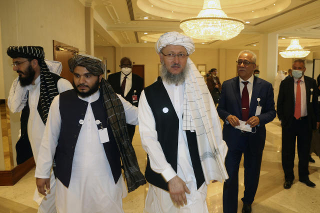Deputy Head of Political Office of the Taliban Abdul Salam Hanafi, center, heads to attend the opening session of the peace talks between the Afghan government and the Taliban in Doha, Qatar, Saturday, Sept. 12, 2020. (AP Photo/Hussein Sayed)