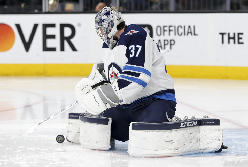 Connor Hellebuyck leads a strong defense in Winnipeg. (AP Photo/John Locher)