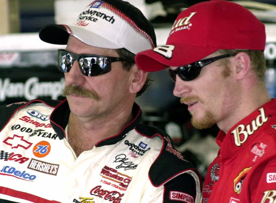 FILE - In this Friday, Feb. 9, 2001 file photo, NASCAR drivers Dale Earnhardt, left, and his son Dale Jr., stand together during a break in practice at the Daytona International Speedway in Daytona Beach, Fla.