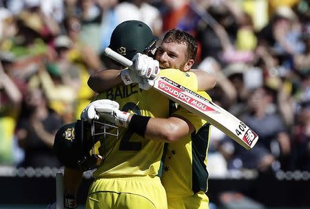 Australia's Aaron Finch (R) celebrates with team mate and captain George Bailey after reaching his century during the Cricket World Cup match against England at the Melbourne Cricket Ground (MCG) February 14, 2015. REUTERS/Hamish Blair