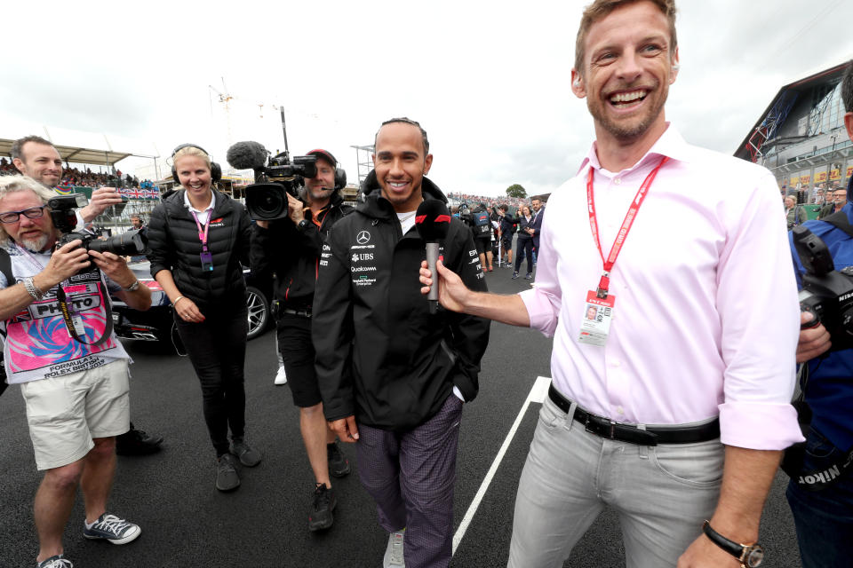 Mercedes driver Lewis Hamilton speaks to Jenson Button during the British Grand Prix at Silverstone, Towcester.