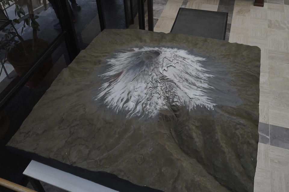 FILE - A model of the Popocatépetl volcano is displayed at the National Center for Disaster Prevention of Mexico in Mexico City, Feb. 8, 2023. The 17,797-foot mountain is known affectionately as “El Popo” and has been belching toxic fumes, ash and lumps of incandescent rock persistently for almost 30 years. (AP Photo/Marco Ugarte, File)