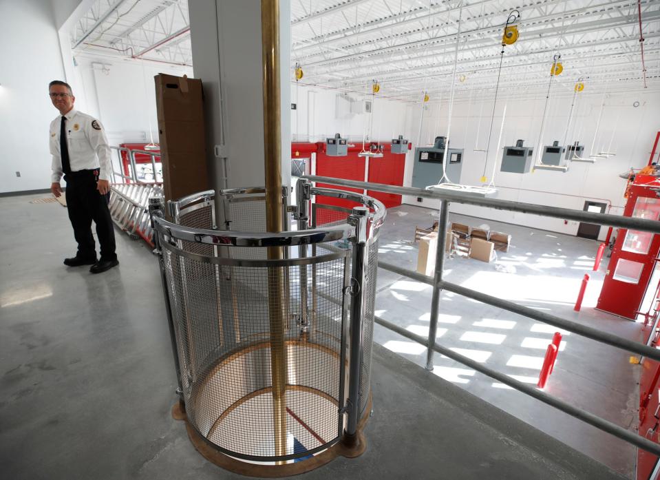 DeLand Fire Chief Todd Allen takes visitors through the new Fire Station 81, which includes a functional fire pole.