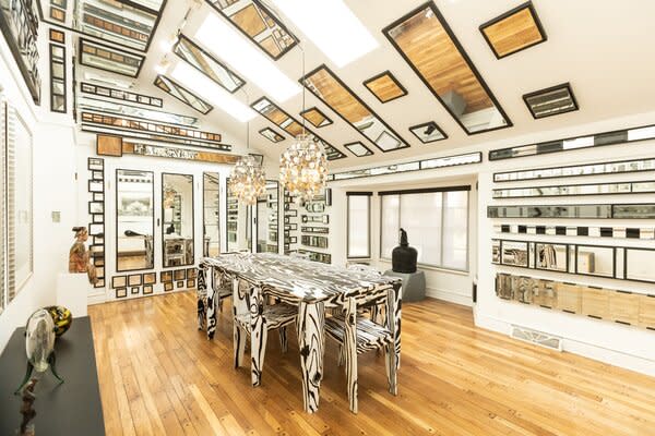 The various shaped mirrors lining the dining room offers a buffet of conversation starters.