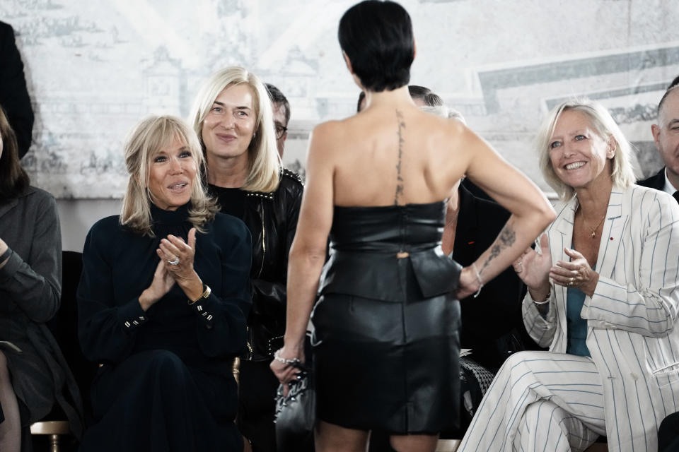 French President's wife Brigitte Macron, left, and Secretary of State in charge of People with Disabilities Sophie Cluzel, right, applaud an amputee model during the 'Victoire, on defile!' (Victory, we walk!) fashion show, at the Hotel des Invalides in Paris, Wednesday, Sept. 29 2021. A new collection by Italian designer Fabio Porlod will feature female amputees and women who have been injured. (AP Photo/Thibault Camus)