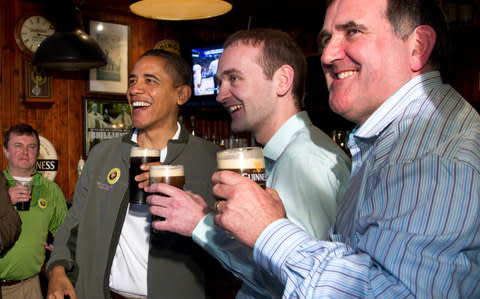 President Barack Obama drinks a Guinness with his ancestral cousin from Moneygall Ireland Henry Healy - Credit: AP