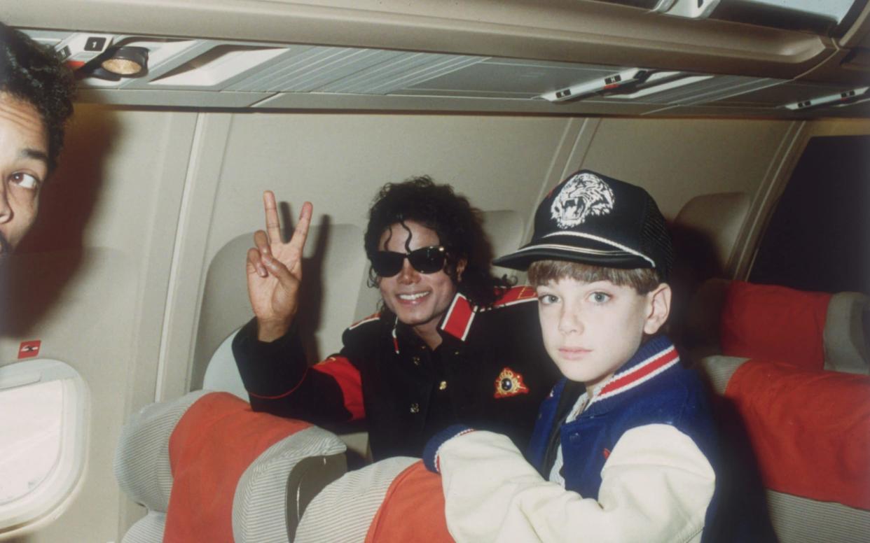 Michael Jackson with 10 year old Jimmy Suchcraft on the tour plane on 11th of July 1988 - Hulton Archive