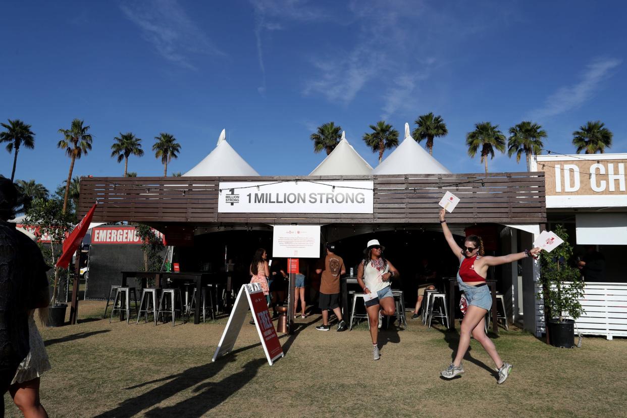 Gladys Godoy, left, and Isa Vizcarra dance to Morgan Wade as they welcome people into a sober space put on by an organization called 1 Million Strong during Stagecoach country music festival at the Empire Polo Club in Indio, Calif., on Saturday, April 29, 2023.