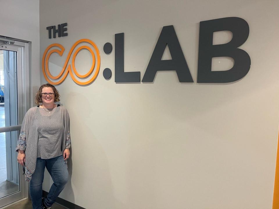 Lisa Watson, the property manager at Madjax poses next to the CO:LAB sign. Along with being the property manager, she also oversees everything that goes on at the CO:LAB.