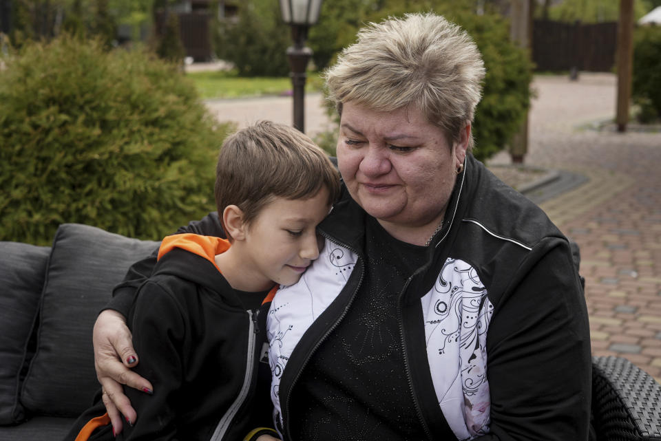 Nina Poliakova comforts her son Andrii Hinkin at the recovery camp for children and their mothers affected by the war near Lviv, Ukraine, Wednesday, May 3, 2023. A generation of Ukrainian children have seen their lives upended by Russia's invasion of their country. Hundreds of kids have been killed. For the survivors, the wide-ranging trauma is certain to leave psychological scars that will follow them into adolescence and adulthood. UNICEF says an estimated 1.5 million Ukrainian children are at risk of mental health issues. (AP Photo/Vasilisa Stepanenko)