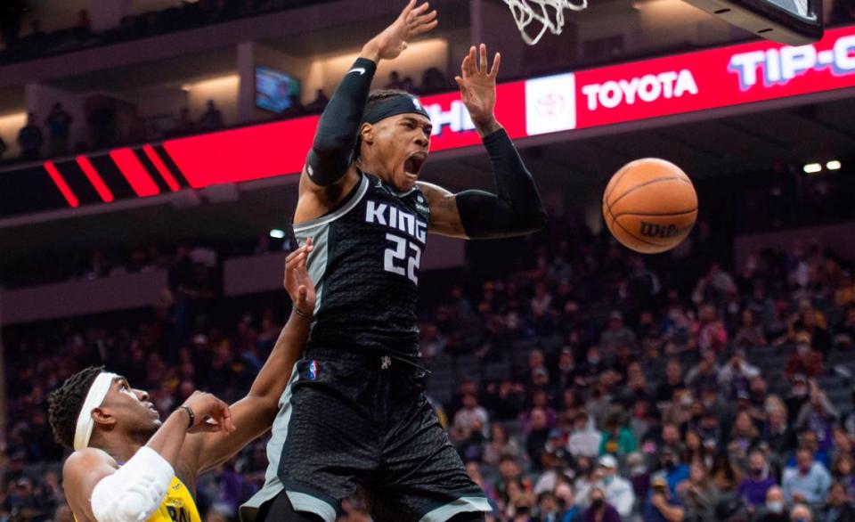 Sacramento Kings center Richaun Holmes (22) follows through on a dunk against Golden State Warriors center Kevon Looney (5) on Sunday, Oct. 24, 2021 during an NBA basketball game at Golden 1 Center in Sacramento.