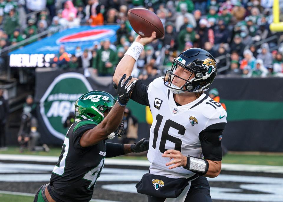 Jaguars quarterback Trevor Lawrence throws under pressure from the Jets' Javelin Guidry.