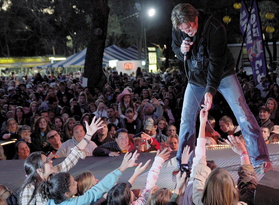 Billy Ray Cyrus entertains the crowed at the Mullet Festival in 2009. It was the second performanace at the festival for Cyrus, who first performed there in 1992.