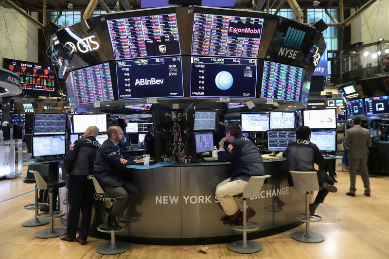 Traders look at price monitors as they work on the floor at the New York Stock Exchange (NYSE) in New York City, New York, U.S., January 3, 2019. REUTERS/Shannon Stapleton