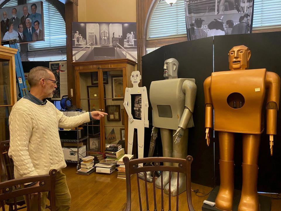 John Weeks, at left, points to Elektro (center robot) Monday at the Mansfield Memorial Museum, which his grandfather John Weeks, an electrical engineer at Westinghouse, built, and his uncle the late Jack Weeks restored and repaired and donated to the museum in 2004.