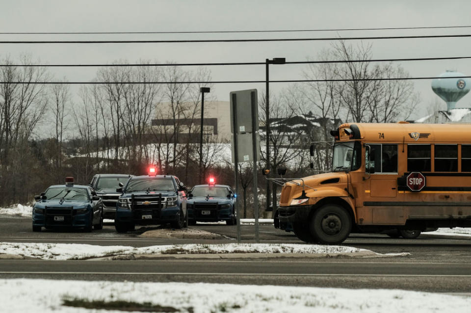 Police cars restrict access to Oxford High School following a shooting in Oxford, Michigan. 