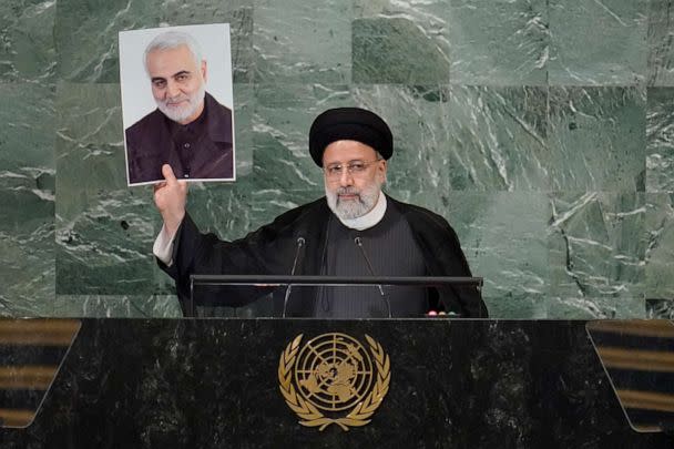 PHOTO: President of Iran Ebrahim Raisi holds up a photo of slain Iranian Gen. Qassem Soleimani as he addresses the 77th session of the United Nations General Assembly, Wednesday, Sept. 21, 2022 at U.N. headquarters.  (Mary Altaffer/AP)