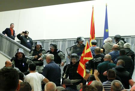 Police try to stop protesters entering Macedonia's parliament after the governing Social Democrats and ethnic Albanian parties voted to elect an Albanian as parliament speaker in Skopje. Macedonia April 27, 2017. REUTERS/Ognen Teofilovski