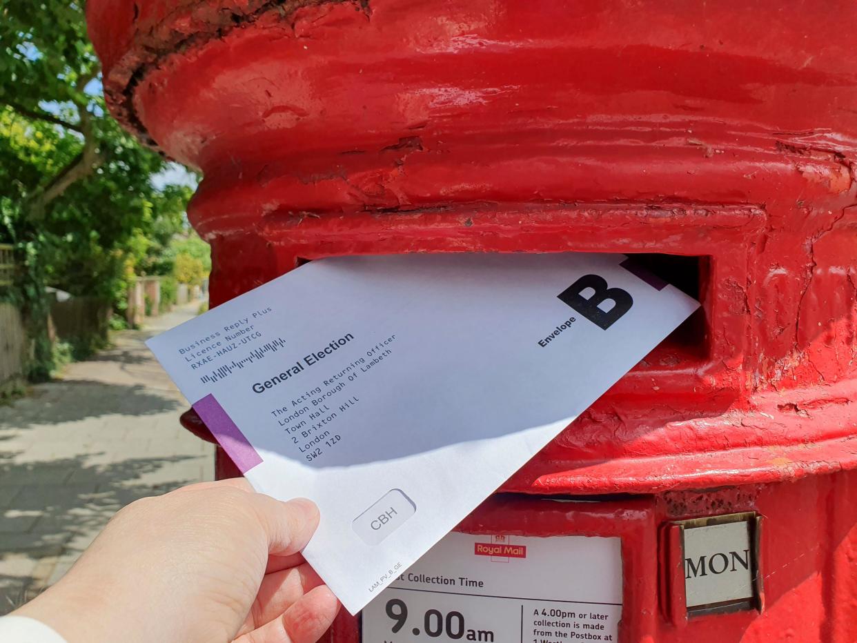 London, UK. 24th June, 2024. A postal vote for the 2024 general election being posted in a letter box in Clapham, Lambeth. Although the elections date is 4 July, people with postal votes who have already made up their minds can vote early, Credit: Anna Watson/Alamy Live News
