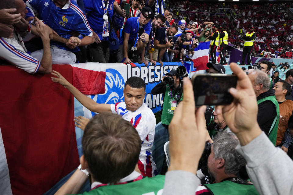 France's Kylian Mbappe greets fans before the World Cup semifinal soccer match between France and Morocco at the Al Bayt Stadium in Al Khor, Qatar, Wednesday, Dec. 14, 2022. (AP Photo/Manu Fernandez)