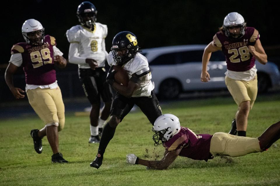 Trayvon Jean of Golden Gate runs that ball against Riverdale during their spring football game on Wednesday, May 24, 2023, at Riverdale High School in Fort Myers.
