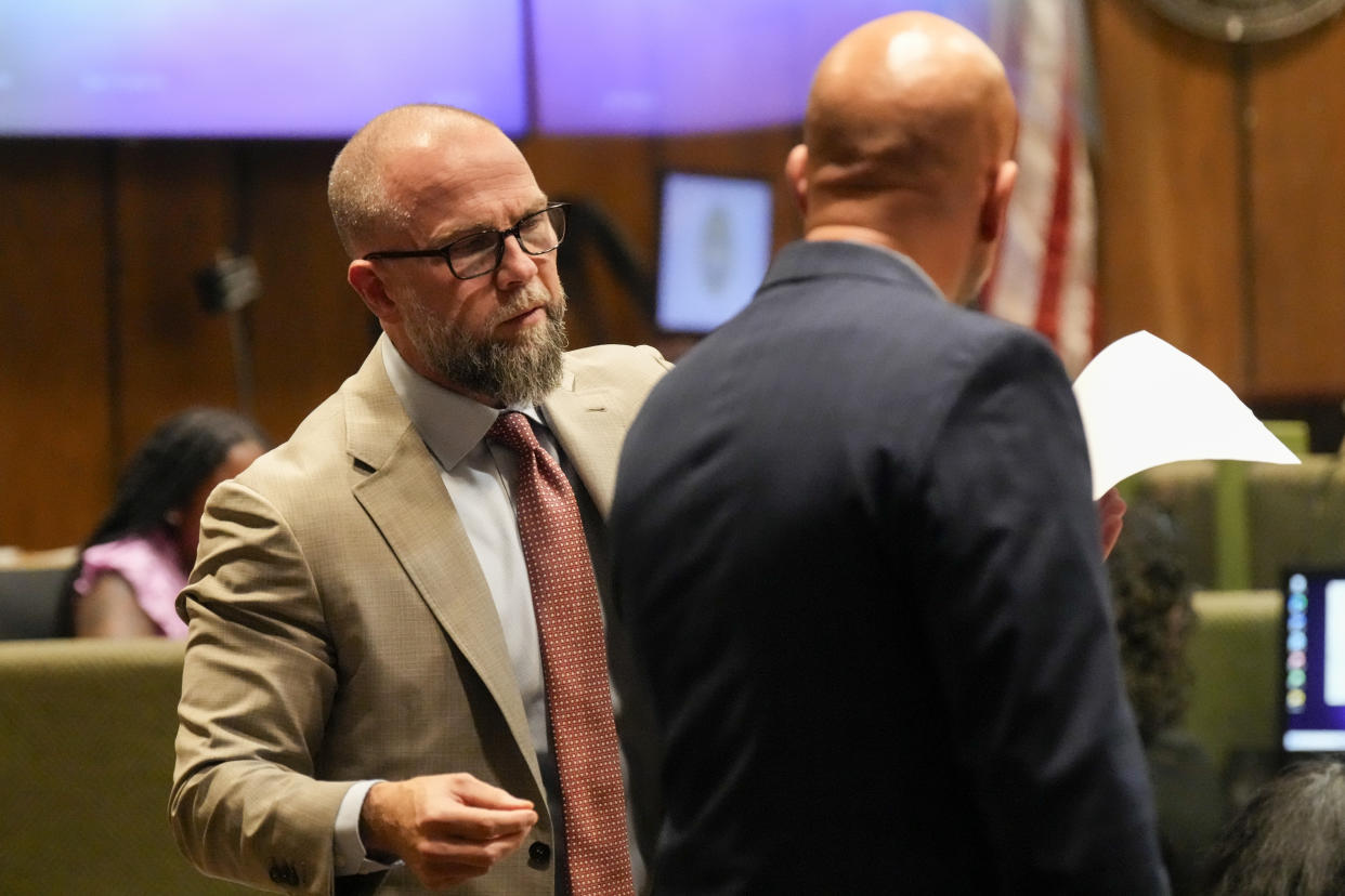 Defendant Justin Johnson's attorney Luke Evans, left, speaks with Paul Hagerman, Shelby County deputy district attorney, right, during Johnson's trial for the murder of rapper Young Dolph, Tuesday, Sept. 24, 2024, in Memphis, Tenn. (AP Photo/George Walker IV, Pool)