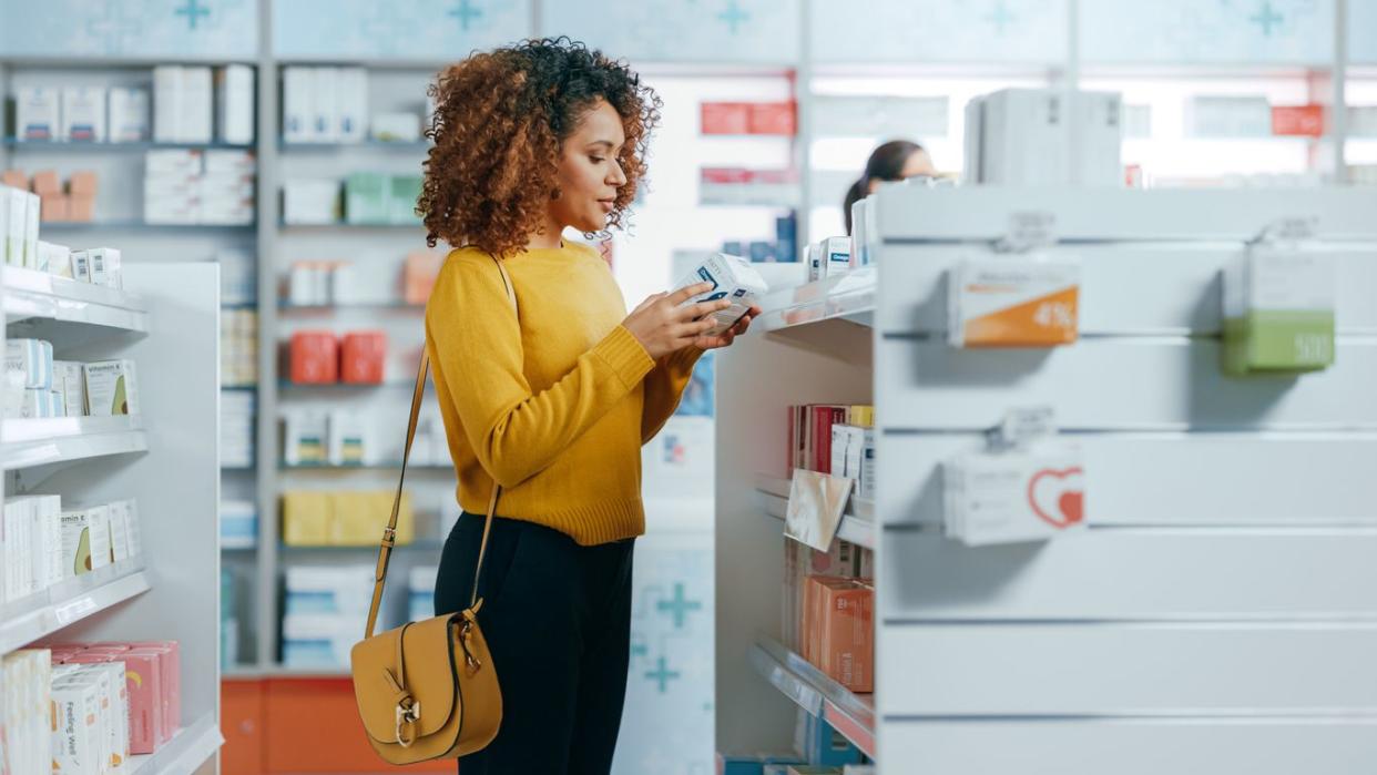 Woman Choosing to Buy Medicine
