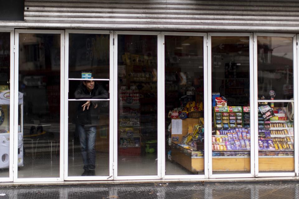 A man stands inside a store without power during a blackout, in Buenos Aires, Argentina, Sunday, June 16, 2019. Argentina and Uruguay were working frantically to return power on Sunday, after a massive power failure left large swaths of the South American countries in the dark. (AP Photo/Tomas F. Cuesta)