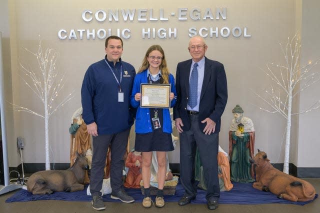 CEC Principal Matthew Fischer , Hailey Morath and Dick Newbert, editor of TheLegacyof1776.Com, are all smiles as Hailey receives her certificate and scholarship.