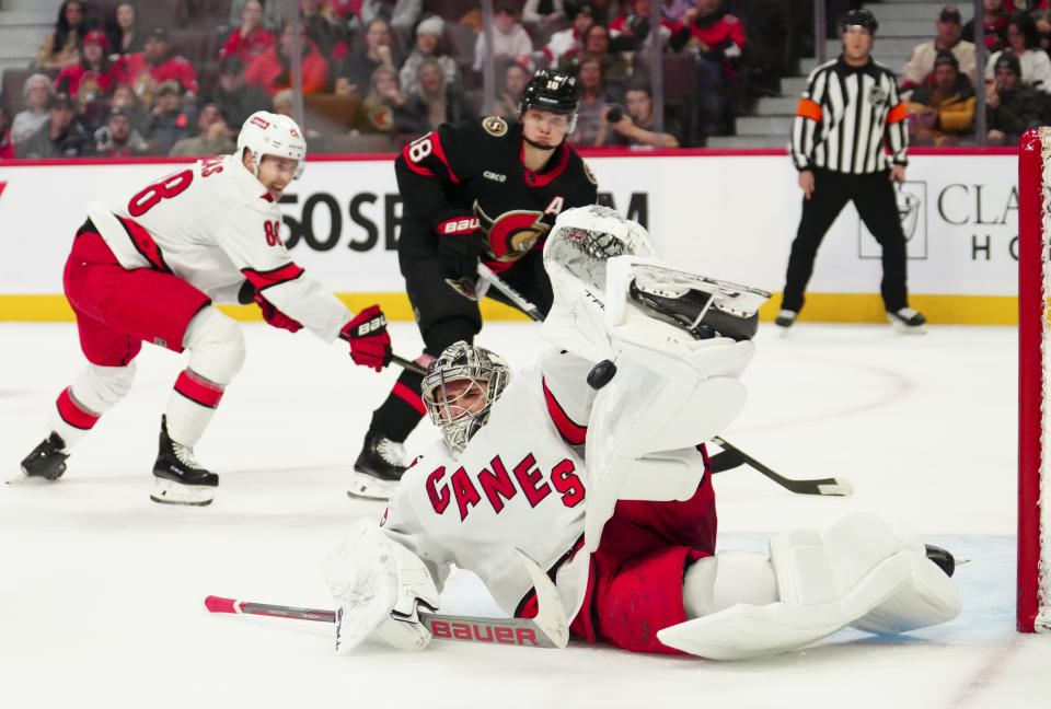 Carolina Hurricanes goaltender Pyotr Kochetkov (52) makes a pad save while taking on the Ottawa Senators during the second period of an NHL hockey match in Ottawa, Ontario, on Tuesday, Dec. 12, 2023. (Sean Kilpatrick/The Canadian Press via AP)