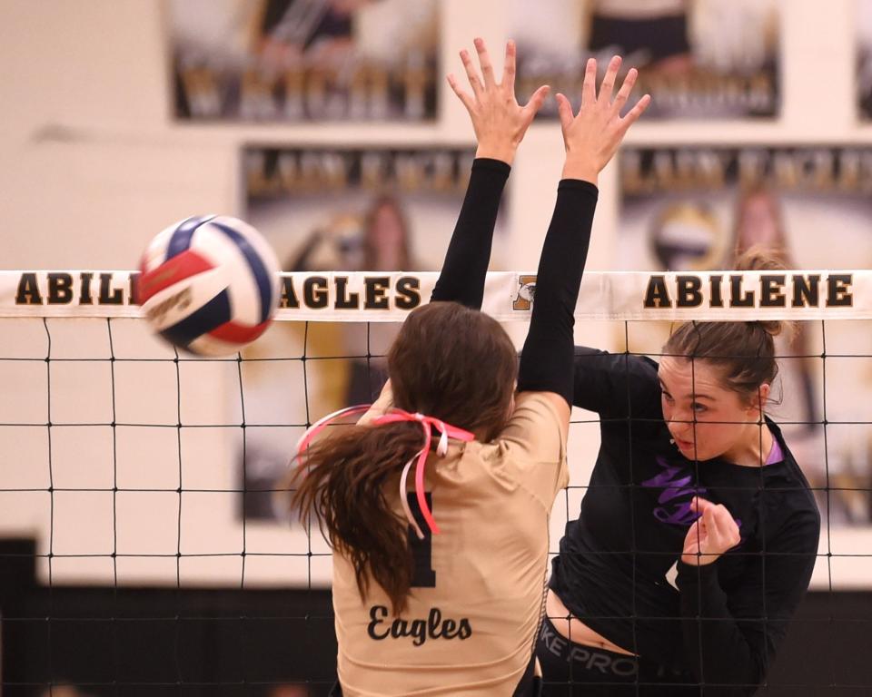 Abilene Wylie's Aliyah Jowers, right, hits the ball as an Abilene High player defends. Wylie beat the Lady Eagles 25-27, 25-15, 26-24, 25-21 in the District 4-5A match Tuesday, Oct. 3, 2023, at Eagle Gym.