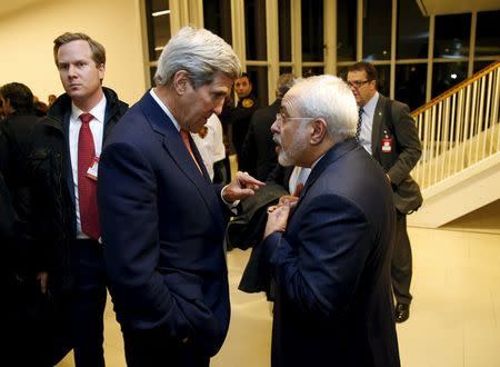 U.S. Secretary of State John Kerry talks with Iranian Foreign Minister Javad Zarif after the International Atomic Energy Agency (IAEA) verified that Iran has met all conditions under the nuclear deal, in Vienna January 16, 2016. REUTERS/Kevin Lamarque