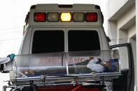 FILE - In this Jan. 10, 2021 file photo, a patient is moved from an ambulance into the COVID-19 treatment center at Dr. Carlos MacGregor Sanchez General Hospital in Mexico City. Mexico City's government announced on Friday, May 7, 2021 that public hospitals dedicated to fighting COVID-19 are experiencing their lowest rate occupancy of the pandemic and the city is slightly easing some restrictions, more than three months after infections peaked in the Mexican capital in January. (AP Photo/Rebecca Blackwell, File)