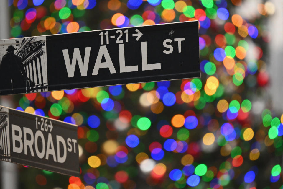 Holiday lights are seen behind a Wall Street sign near the New York Stock Exchange (NYSE) in New York on December 1, 2023. (Photo by ANGELA WEISS / AFP) (Photo by ANGELA WEISS/AFP via Getty Images)