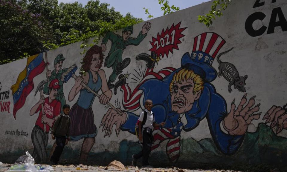 Children pass by a mural depicting Uncle Sam in Caracas this week.