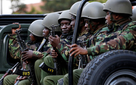 FILE PHOTO: Kenyan police officers drive in their truck as they arrive at the scene where explosions and gunshots were heard at the Dusit hotel compound, in Nairobi, Kenya January 16, 2019. REUTERS/Thomas Mukoya/File Photo