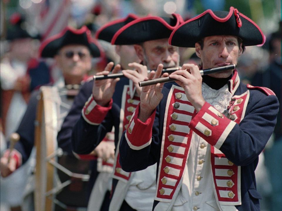 Members of the East Greenwich, Rhode Island, Kentish Guards perform during the Bristol, Rhode Island, Independence Day Parade in 1996.