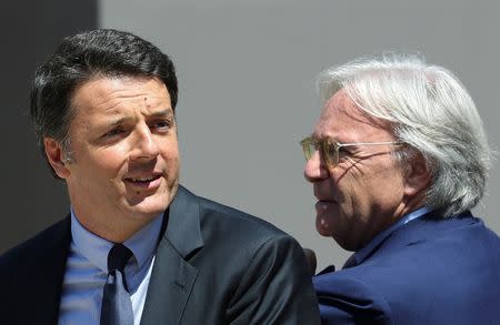 Italy's Prime Minister Matteo Renzi (L) and Diego Della Valle, President and CEO of Tod's, attend a news conference about the latest stage of restoration of the Colosseum by luxury goods firm Tod's in Rome, Italy, July 1, 2016. REUTERS/Alessandro Bianchi