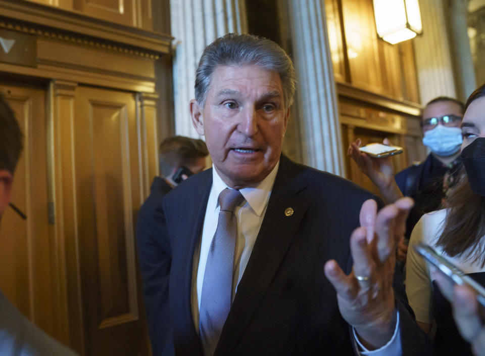 FILE - Sen. Joe Manchin, D-WVa., speaks to reporters as he leaves the chamber after a vote, at the Capitol in Washington, on Nov. 3, 2021. Democrats’ $1.85 trillion package of social and climate initiatives seems afflicted by a maddening parade of hurdles. Looming ahead is the Congressional Budget Office, which could cause problems that would be messy but probably surmountable.(AP Photo/J. Scott Applewhite, File)