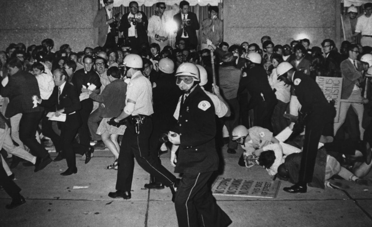 FILE - Chicago Police attempt to disperse demonstrators outside the Conrad Hilton, Democratic National Convention headquarters, Aug. 29, 1968, in Chicago. (AP Photo/Michael Boyer, File)