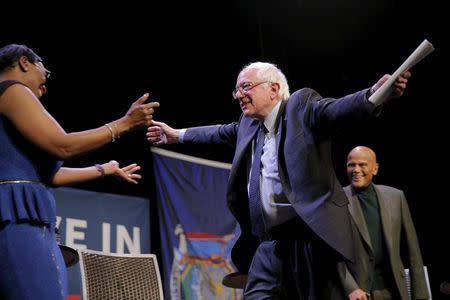 U.S. Democratic presidential candidate and U.S. Senator Bernie Sanders hugs former Ohio State Senator Nina Turner at a campaign "Community Conversation" at the Apollo Theater in Harlem, in New York, New York April 9, 2016. REUTERS/Brian Snyder