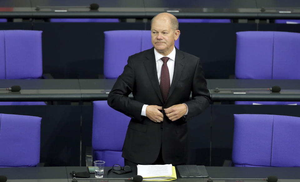 File - In this Tuesday, Sept. 29, 2020 file photo German Finance Minister Olaf Scholz arrives for a budget debate as part of a meeting of the German federal parliament, Bundestag, at the Reichstag building in Berlin, Germany. German lawmakers presenting a report into the collapse of payment processing company Wirecard accused the country's finance minister and auditors Ernst and Young of numerous oversight failings. (AP Photo/Michael Sohn, file)