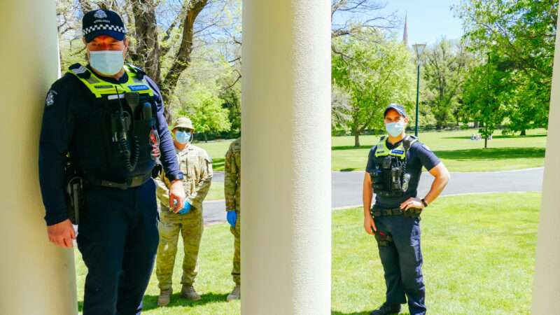 Melbourne police officers wearing COVID-19 face masks.