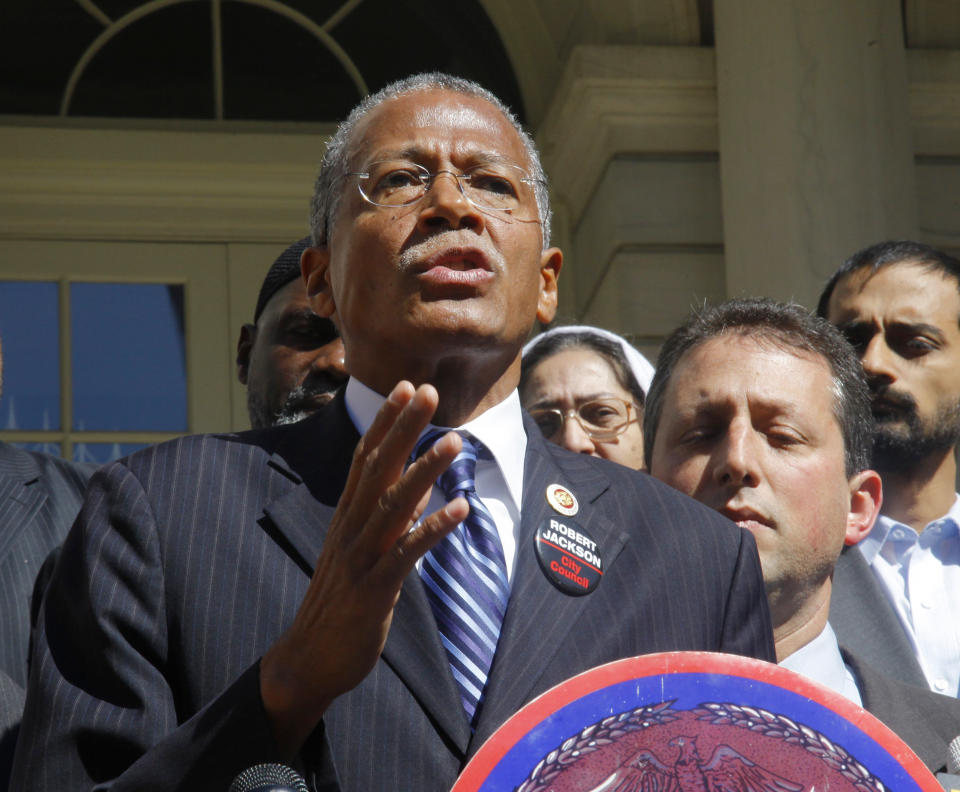 FILE- This Oct. 6, 2011 file photo, shows Robert Jackson when he was a New York City councilman, as he speaks during a news conference on the steps of City Hall in New York. Jackson is challenging incumbent state Sen. Marisol Alcantara in the Sept. 13, 2018, Democratic primary in New York's District 31. Alcantara is among the eight Democratic state senators who now face primary challenges after breaking with their party to join the Independent Democratic Conference, which supported Republican control of the chamber. (AP Photo/Bebeto Matthews, File)