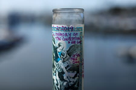 A candle in memory of the Conception and all lost sits at a makeshift memorial near Truth Aquatics as the search continues for those missing in a pre-dawn fire that sank a commercial diving boat near Santa Barbara, California