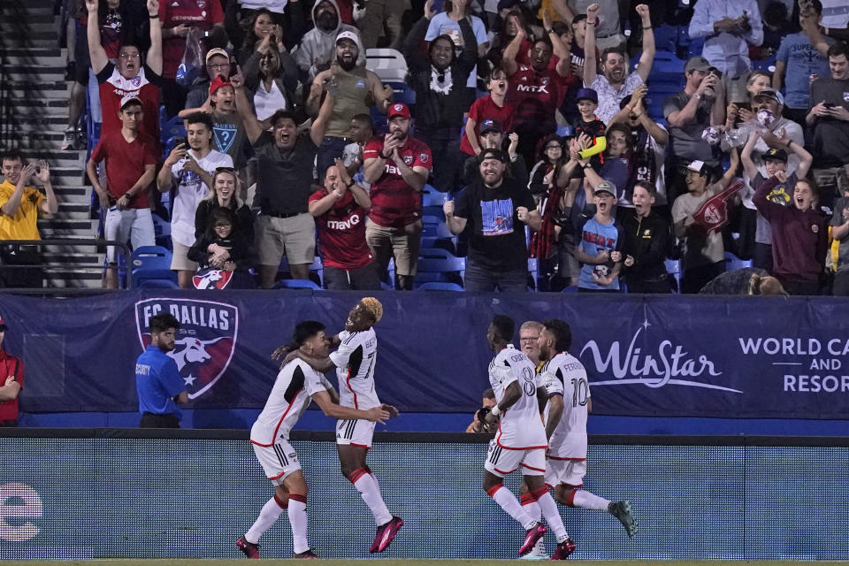 Fans cheer as FC Dallas forward Bernard Kamungo (77) celebrates after his goal with teammates Jader Obrian, left, Jesus Ferreira (10) and Jáder Obrian (8) during the second half of an MLS soccer match against Real Salt Lake, Saturday, April 15, 2023, in Frisco, Texas. (AP Photo/LM Otero)