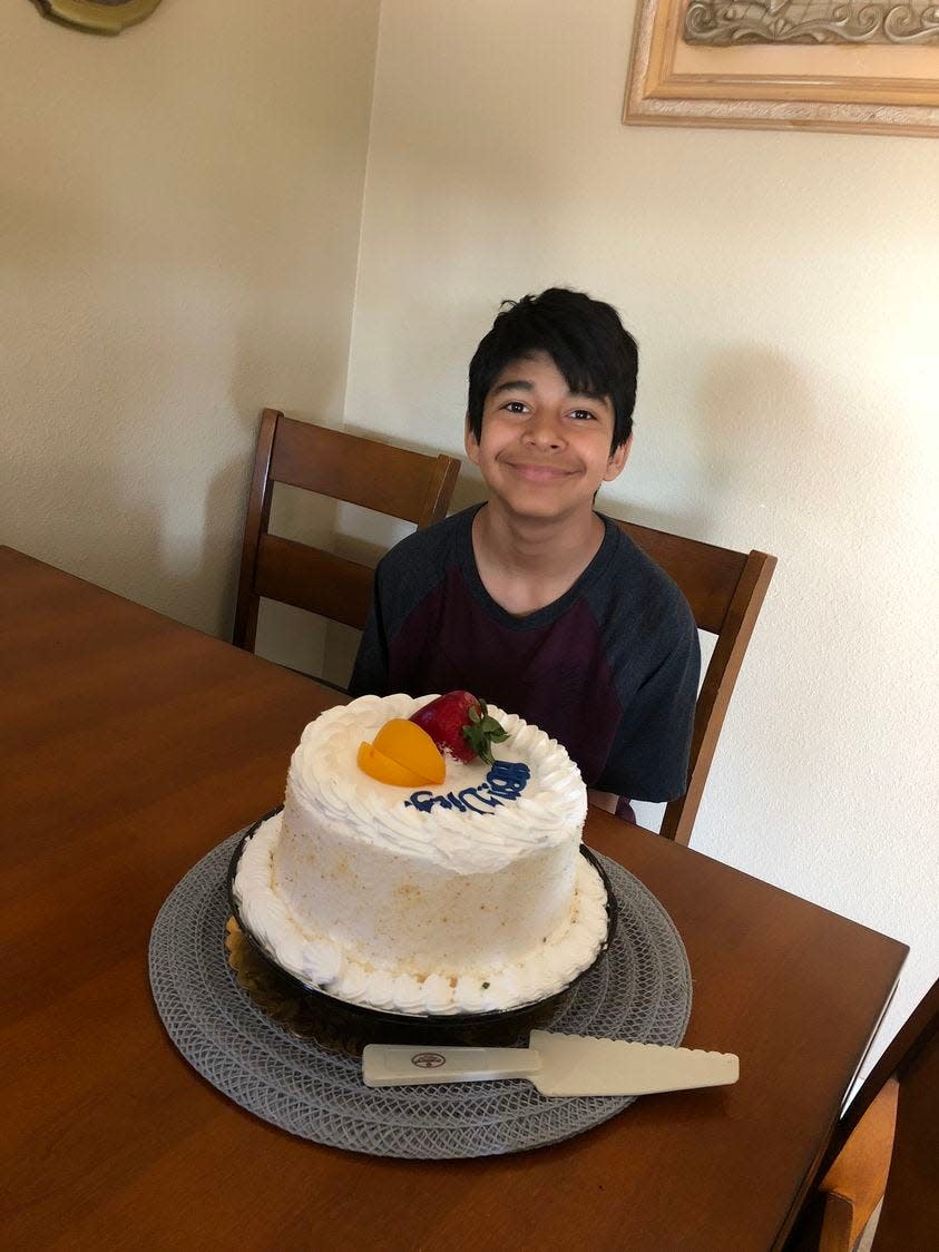 A photo of Diego Stolz posing in front of a cake. Family said they brought up concerns about bullying to school administrators, but were not taken seriously.