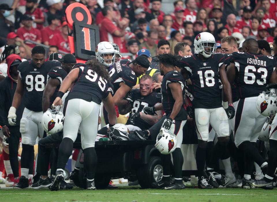 Oct 10, 2021; Glendale, Arizona, USA; Arizona Cardinals tight end Maxx Williams (87) is greeted by teammates while taken off the field after an injury against the San Francisco 49ers during the second quarter at State Farm Stadium.