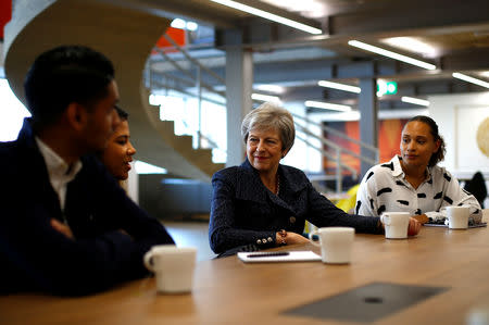 Britain's Prime Minister Theresa May talks to employees at WPP who have come through micro fellowships and apprenticeships, after a roundtable meeting with business leaders whose companies are inaugural signatories of the Race at Work Charter, at the Southbank Centre in London, Britain, October 11, 2018. REUTERS/Henry Nicholls